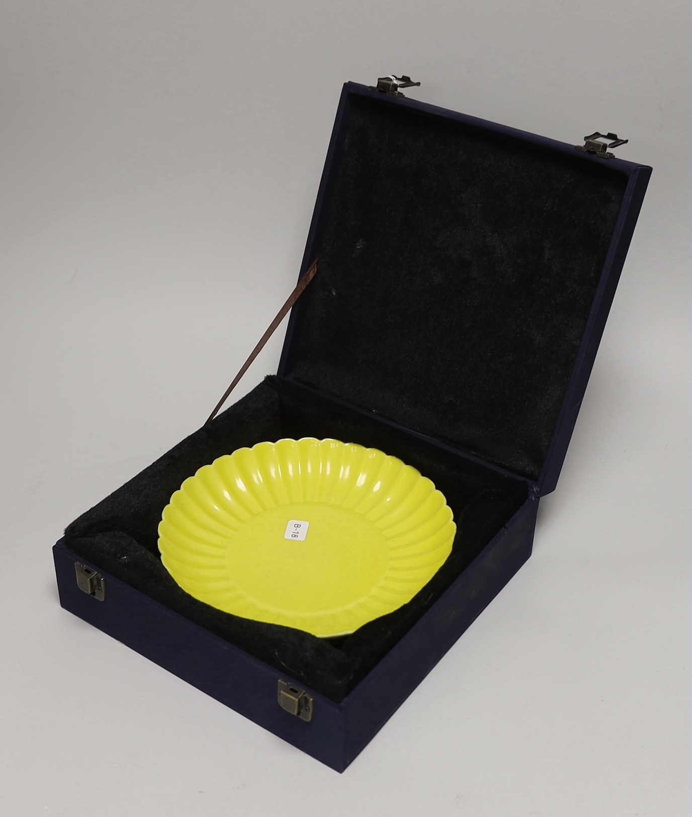 A Chinese yellow ground fluted dish, housed in a fitted case, 20cm in diameter